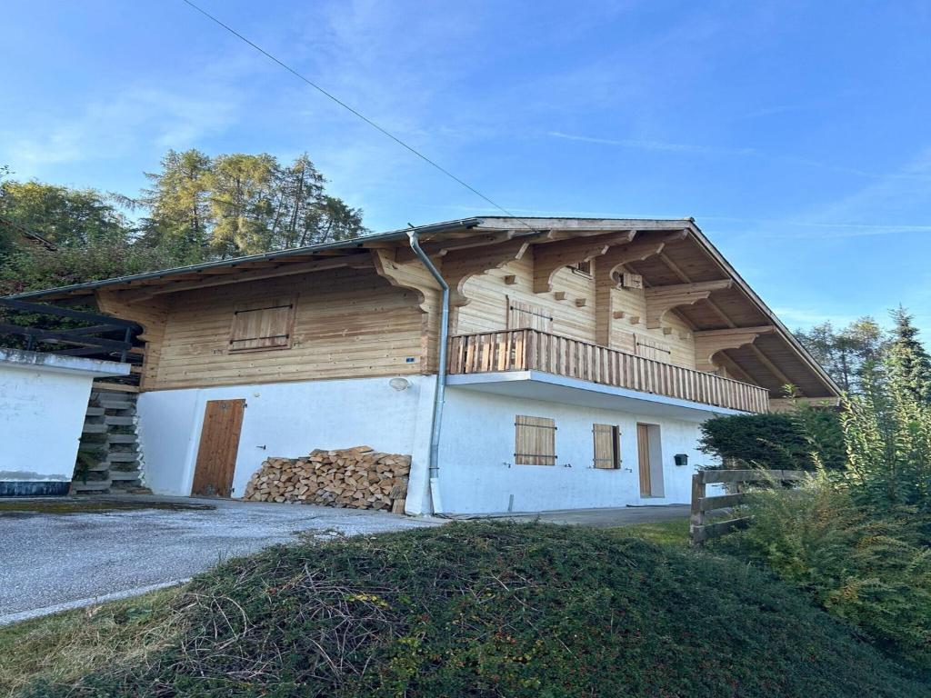 a wooden house with a balcony on top of it at Pet-friendly chalet in Veysonnaz in Veysonnaz