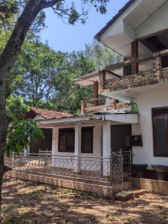 a house with a tree in front of it at flying in stay in Dankotuwa