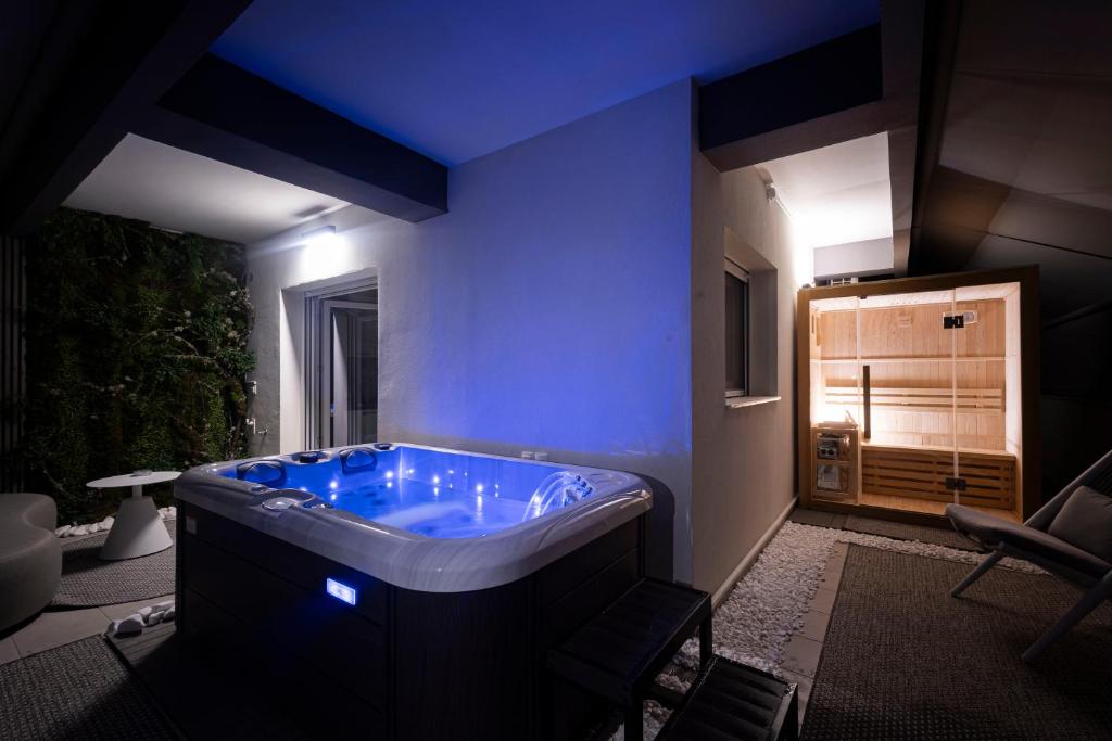 a large bathroom with a tub with a blue ceiling at Edem in Larisa