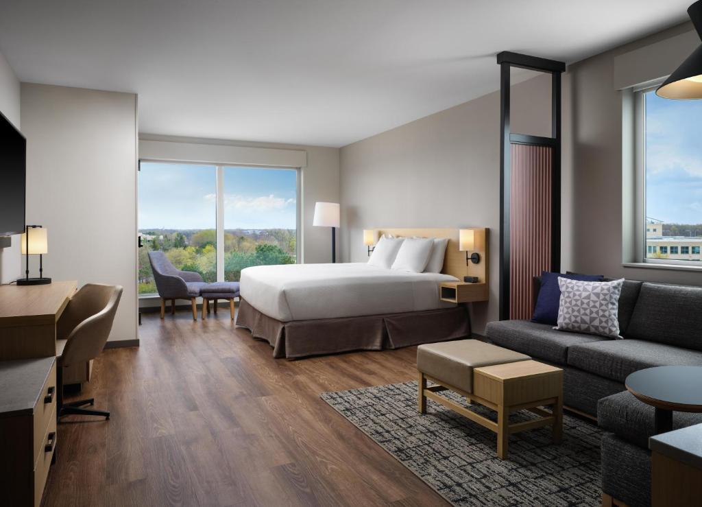 a hotel room with a bed and a couch at The Forester Hotel, part of Unscripted by Hyatt in Lake Forest