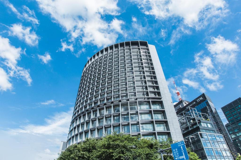 a tall building in front of a blue sky at Hotel Grand Arc Hanzomon in Tokyo