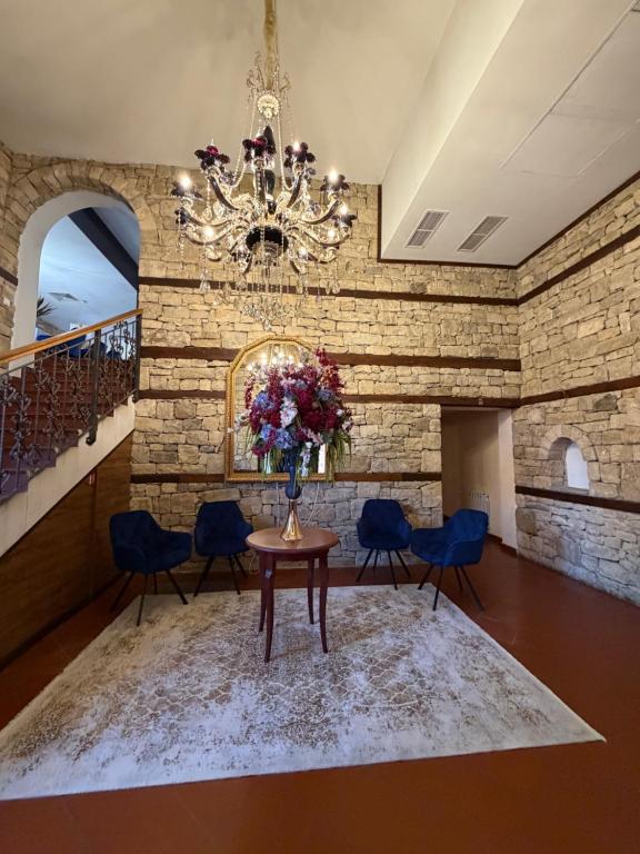 a dining room with a table and chairs and a chandelier at A&N Residence Bolyarka in Arbanasi