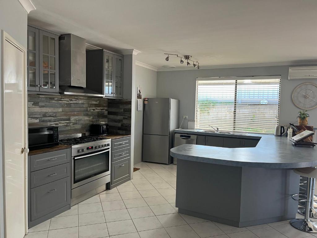 a kitchen with stainless steel appliances and a counter top at Hibiscus Haven in Eaton