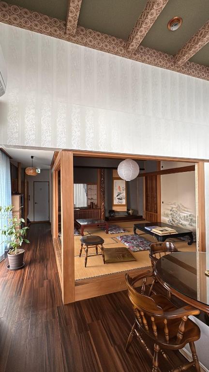a large living room with a table and chairs at 宿杏 Yado Ann in Kofu