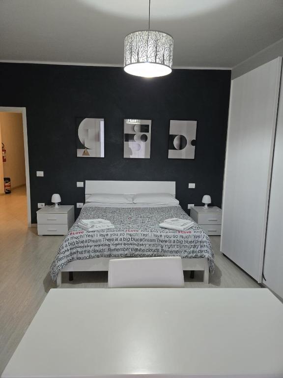 a bedroom with a bed and a black wall at Casa Roncalli in Foligno