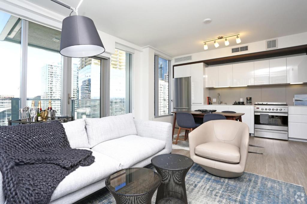 a living room with a white couch and a kitchen at Spera in San Francisco