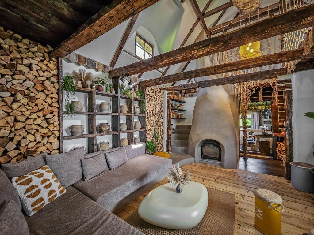a living room with a couch and a fireplace at Nooks by AdyBeca - Panoramic Nook in Şuncuiuş