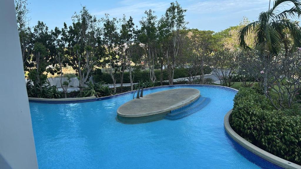 a swimming pool with a slide in a resort at 1 BR Loft Condo in Cha-Am in Cha Am
