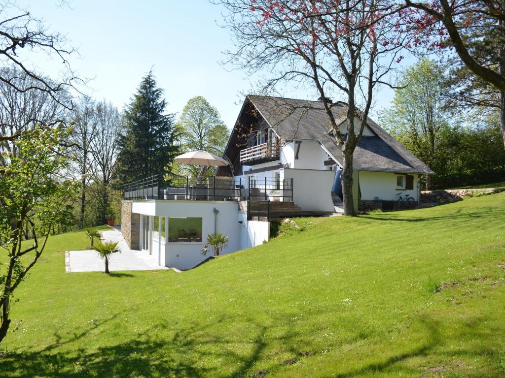a house on top of a grassy hill at stunning Family Gîte Retreat in Stoumont