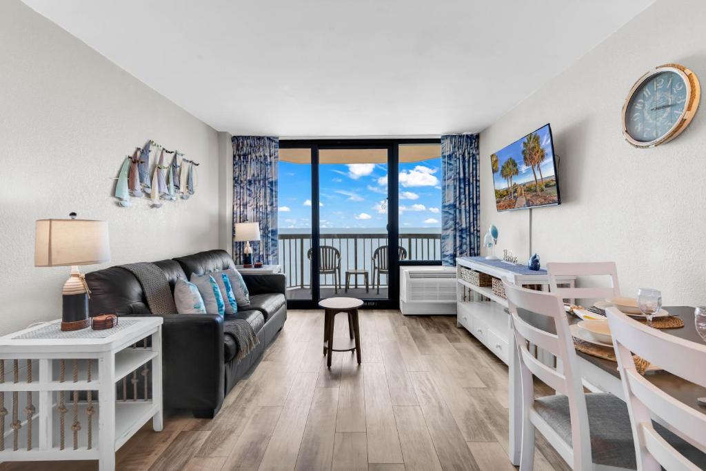 a living room with a couch and a table at Compass Cove 1466 in Myrtle Beach