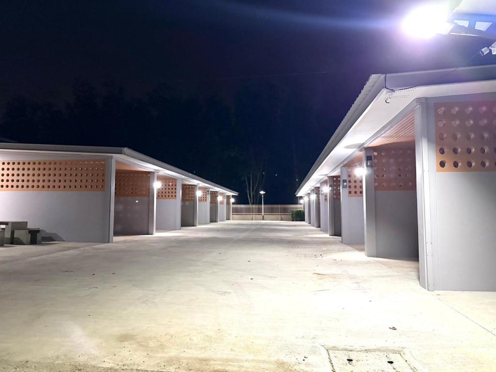 a row of buildings at night with lights at Third Space House in Ban Chak Phak Kut
