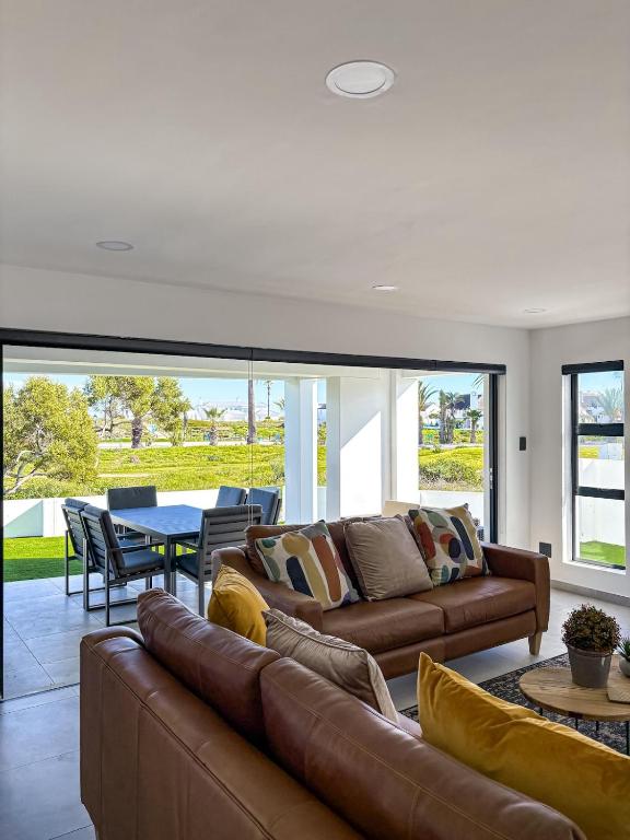 a living room with a couch and a table at Grace Eleven in Stompneusbaai