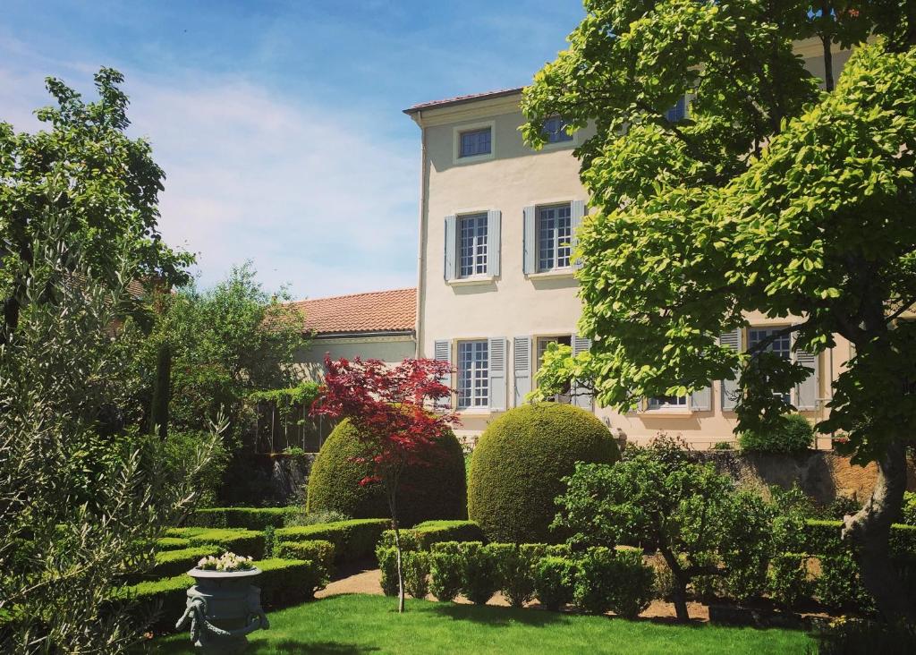 a house with a garden in front of it at Demeure Bouquet in Ambierle