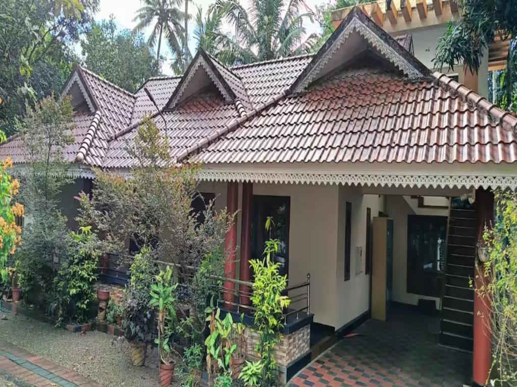 a house with a tiled roof at Villa in Chengannur in Māvelikara