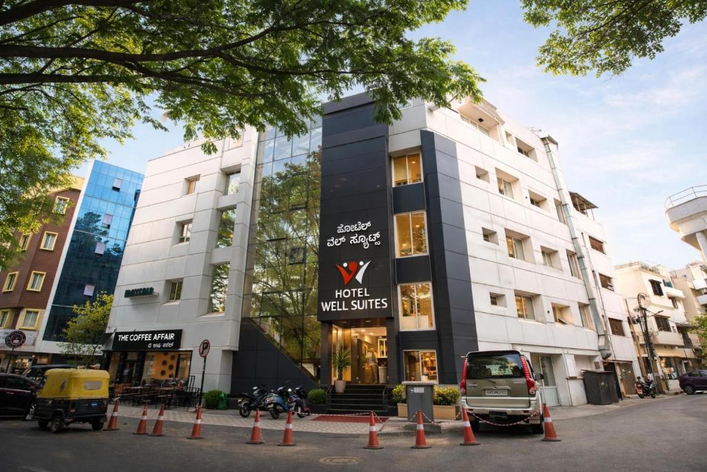 a building with a sign that reads court wild cities at Hotel Well Suites Koramangala in Bangalore
