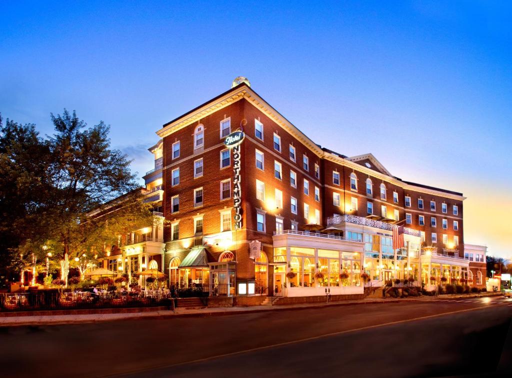 a large building on a city street at night at The Hotel Northampton in Northampton