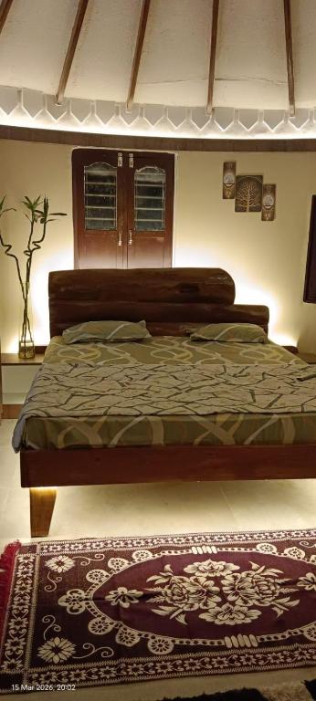 a bedroom with a bed and a rug on the floor at Om Niwas in Bhuj