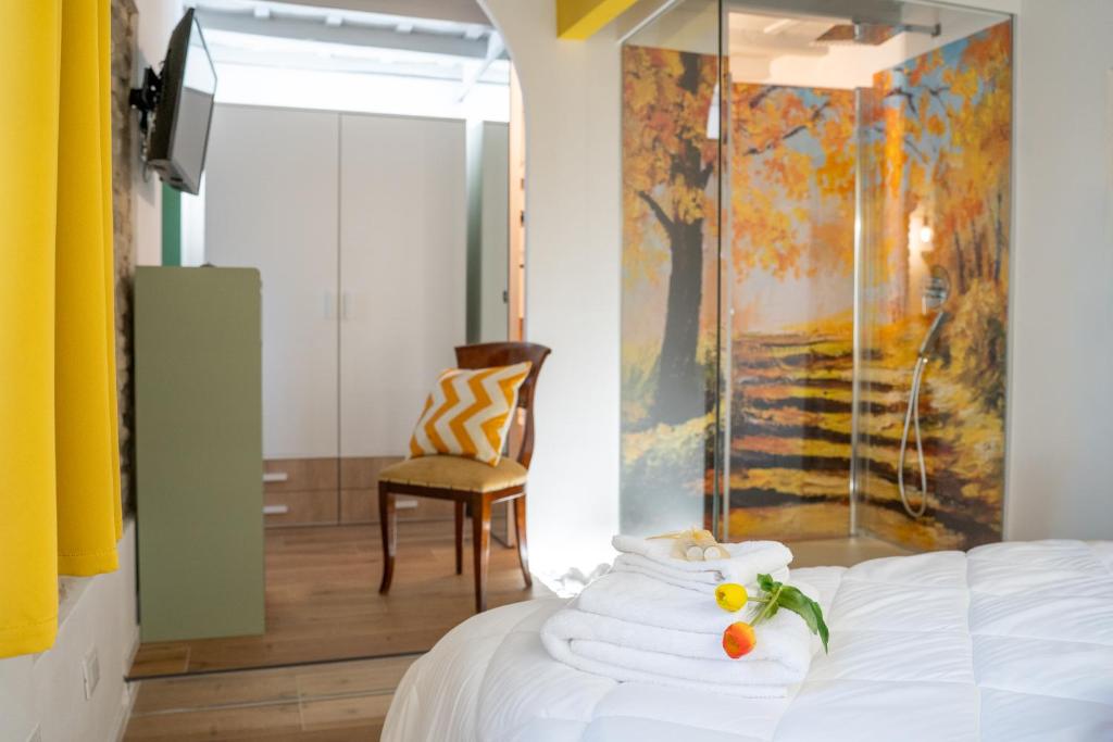 a bedroom with a bed with a painting on the wall at Casa Rachele alloggio turistico in Sabina in Poggio Mirteto