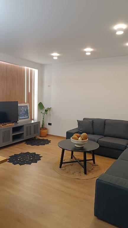 a living room with a couch and a coffee table at Thermi Luxury apartments in Thermi