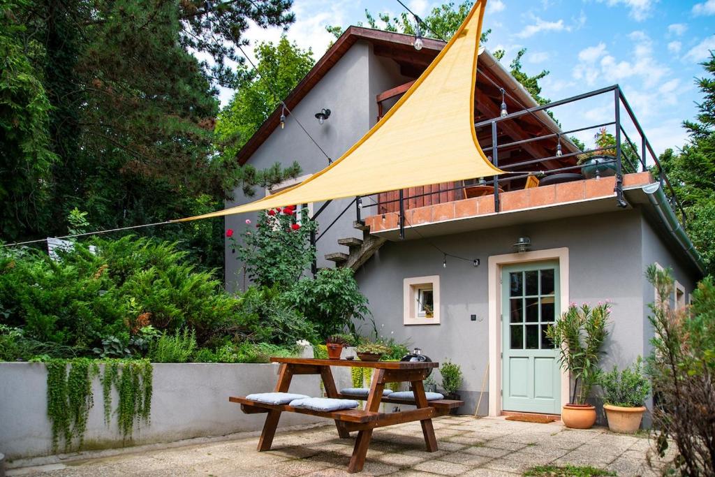 a house with a large yellow sail on top of it at KIS CINKE Guesthouse in Tahitótfalu