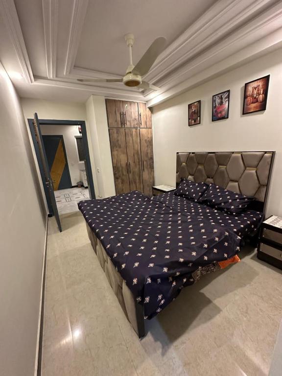 a bedroom with a large bed in a room at Two Bed Appartment in Islamabad