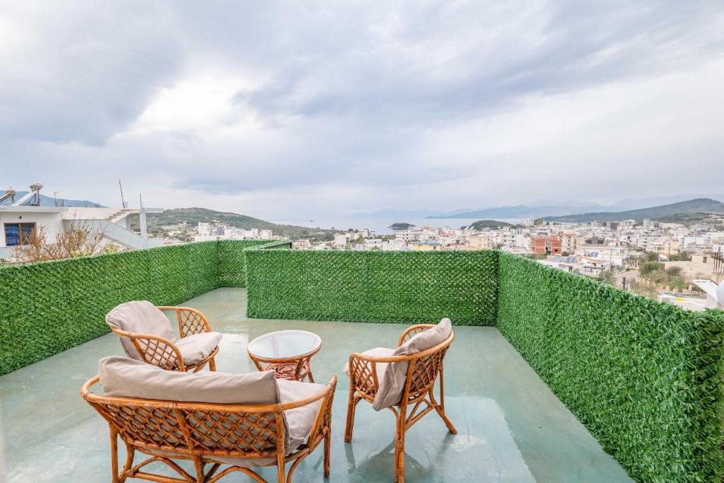 a group of chairs on a balcony with a view at Vila Myrtaj in Ksamil