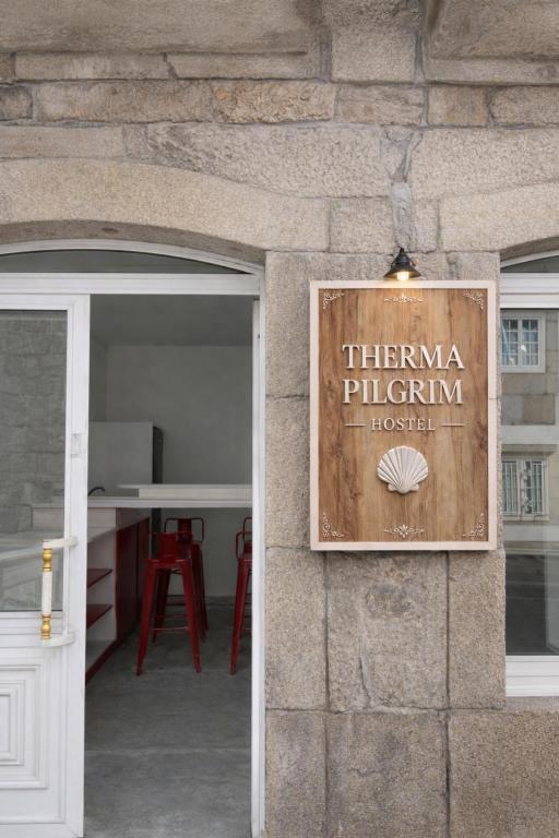 a sign on the side of a building at Therma Pilgrim Hostel in Caldas de Reis