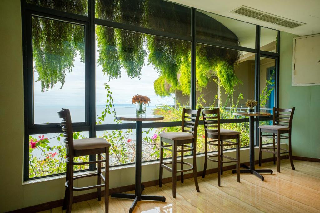 a room with a table and chairs and a large window at Best Hotel in Johor Bahru