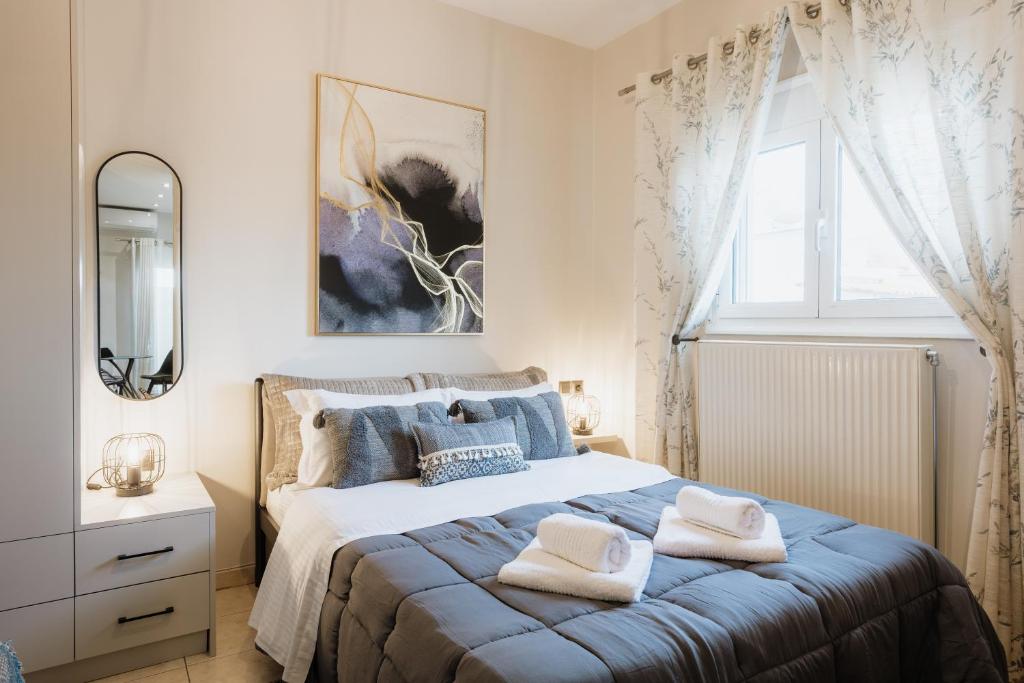 a bedroom with a bed with towels on it at Zoe's Luxury Living in Volos