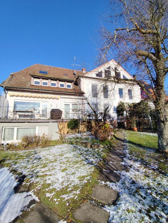 a house with snow on the ground in front of it at Ferienwohnung Iris in Radolfzell am Bodensee