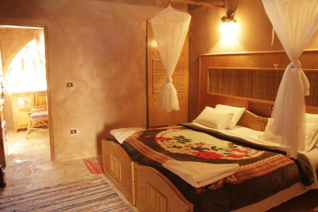 una camera con un grande letto di Eskaleh Eco-Lodge ad Abu Simbel