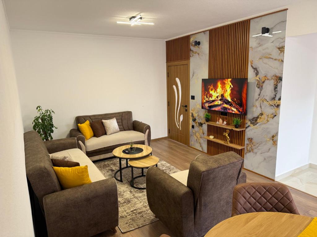 a living room with two couches and a tv at Apartman Đole&Ljuba -Radanovići , Kotor in Ðuranovići