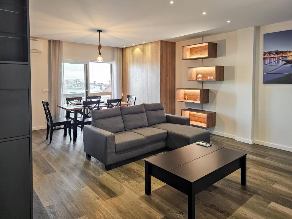 a living room with a couch and a table at Ocean Breeze - Comfortable Ap Close to the Beach in Bicas