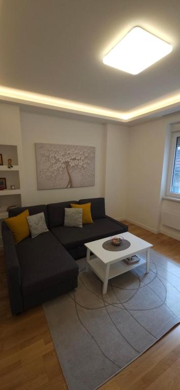 a living room with a couch and a coffee table at Apartment Green Lux in Belgrade