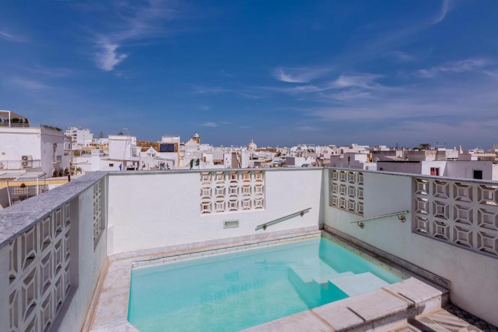a swimming pool on the roof of a building at Patio Suite in Olhão