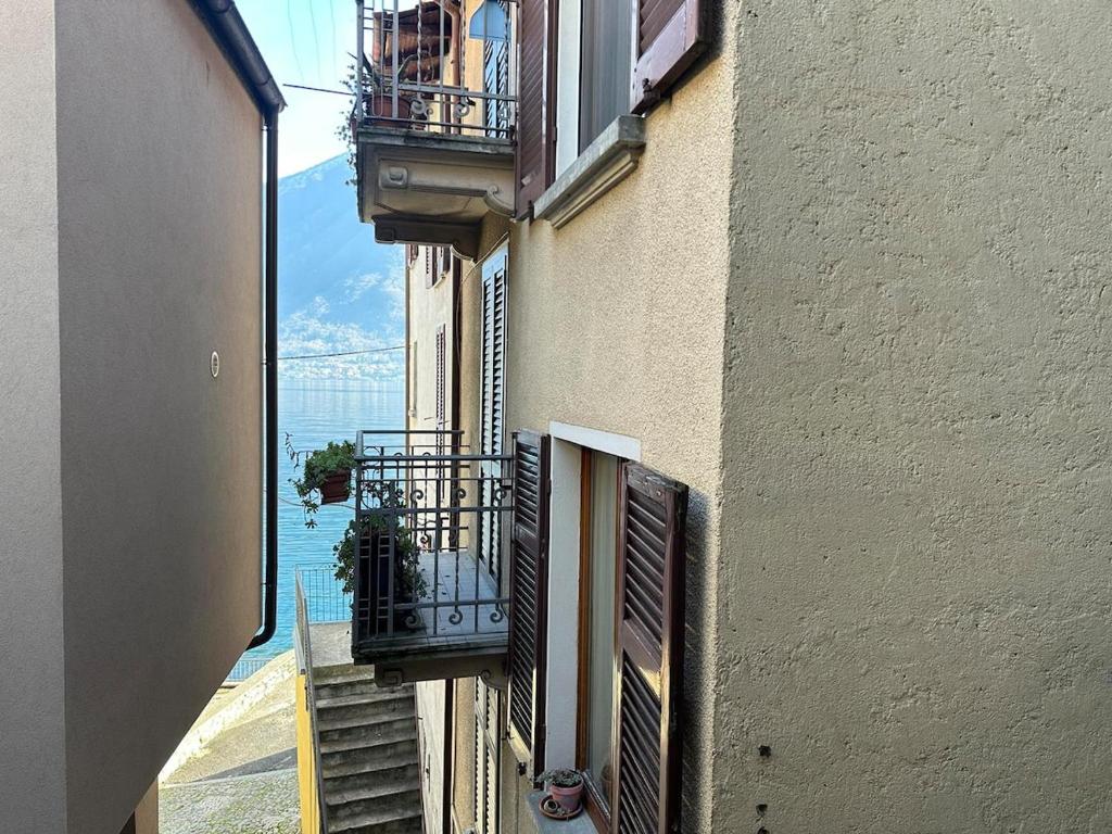 an alley with balconies on the side of a building at White Suite Lakeside in Colonno