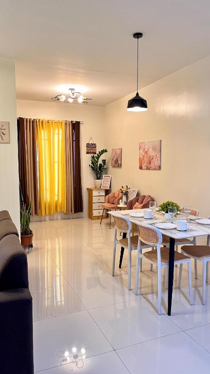 a living room with two tables and a couch at The HappyNest Tagum in Tagum