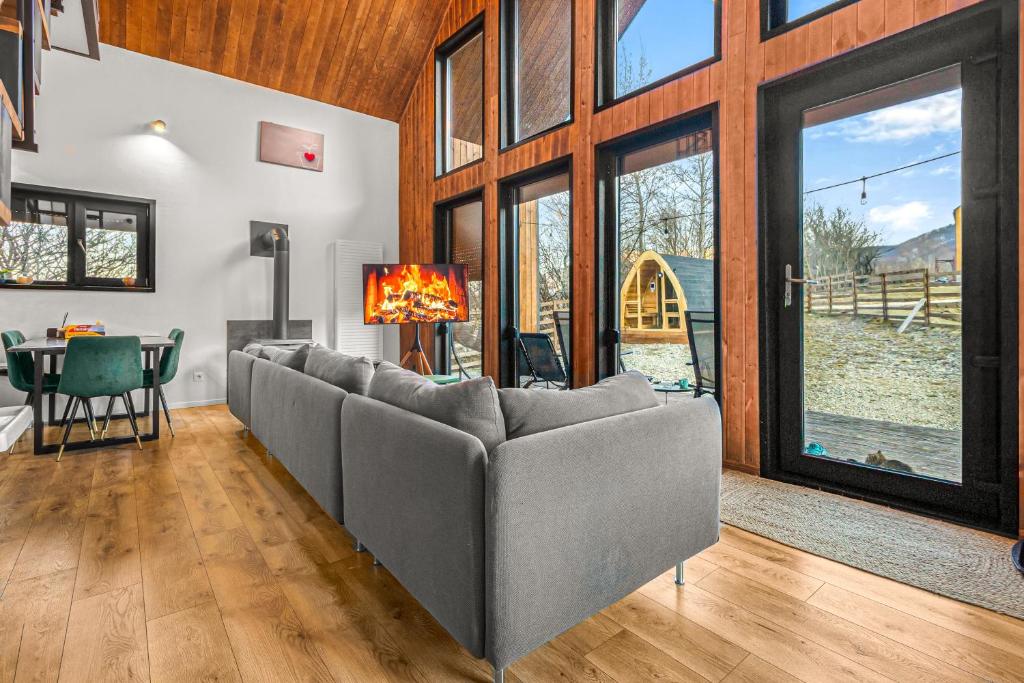a living room with a couch and a table at Cabana Alpinest & Sauna in Bran