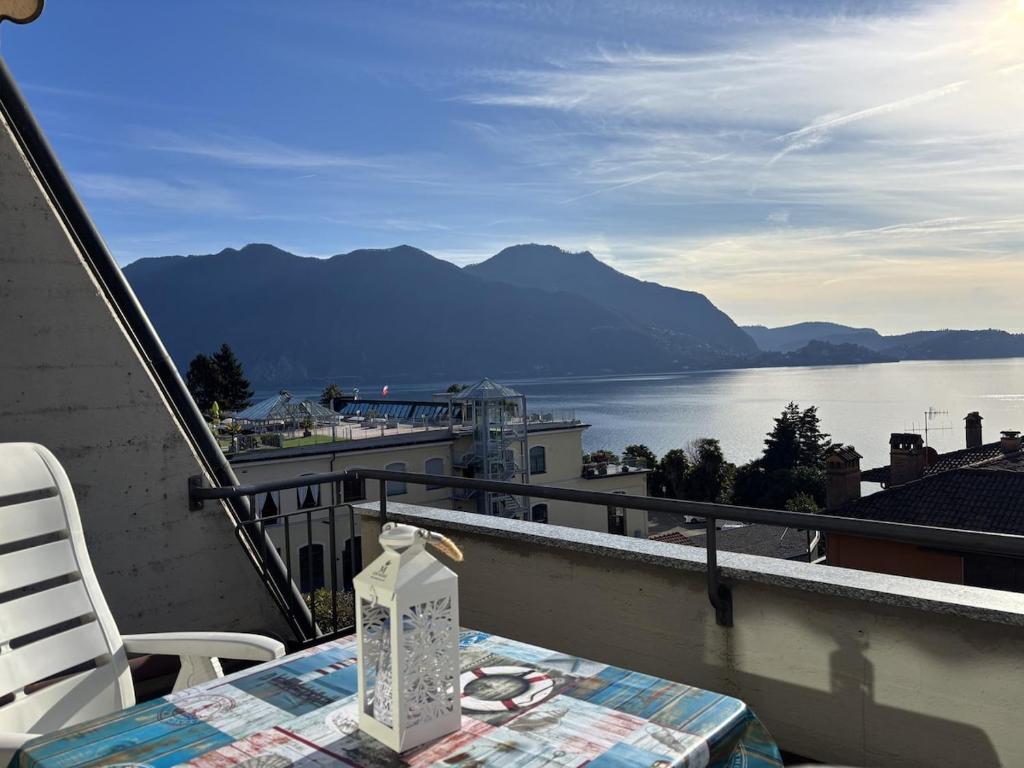 a table and chairs on a balcony with a view of the water at The Lookout in Ghiffa