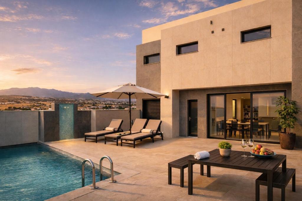 a villa with a swimming pool and a patio at VillasRoyale Rex - no steps, easy access, heated pool & BBQ in Meloneras