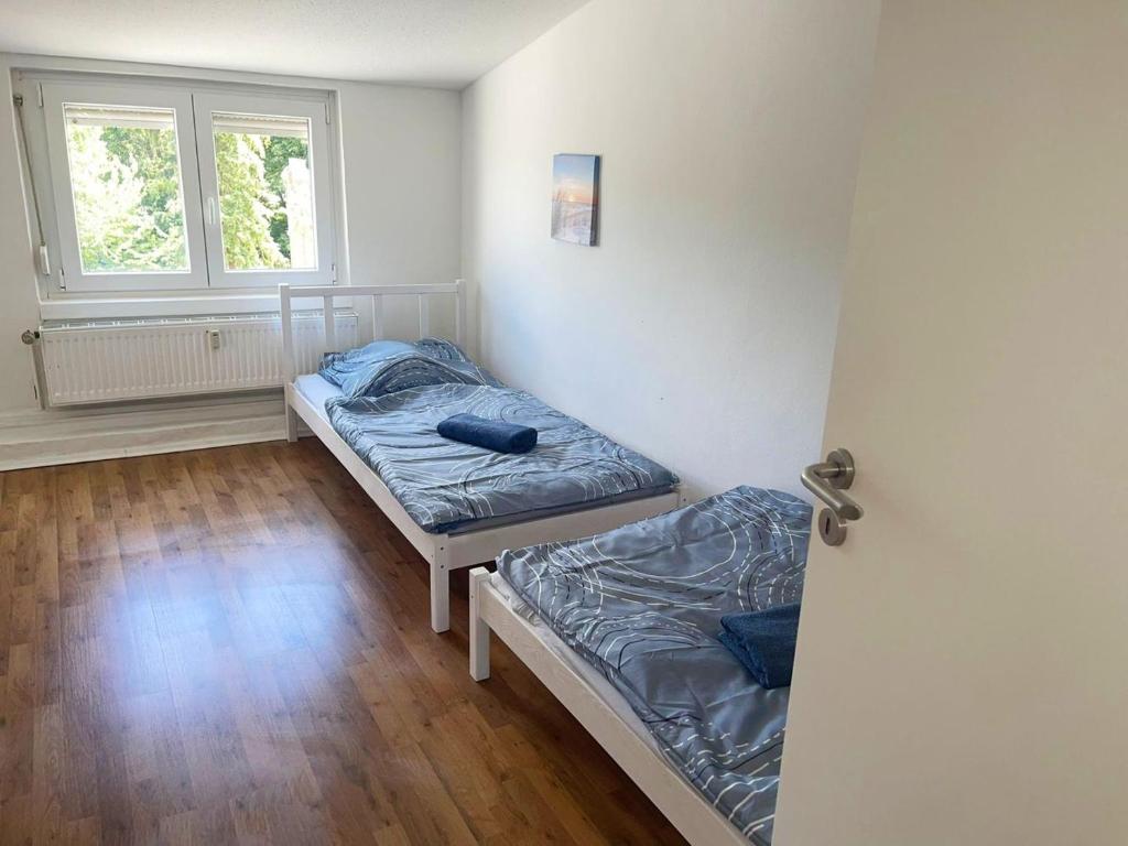 a room with two beds and a window at AC01-AC06 Apartment in Herzogenrath in Herzogenrath