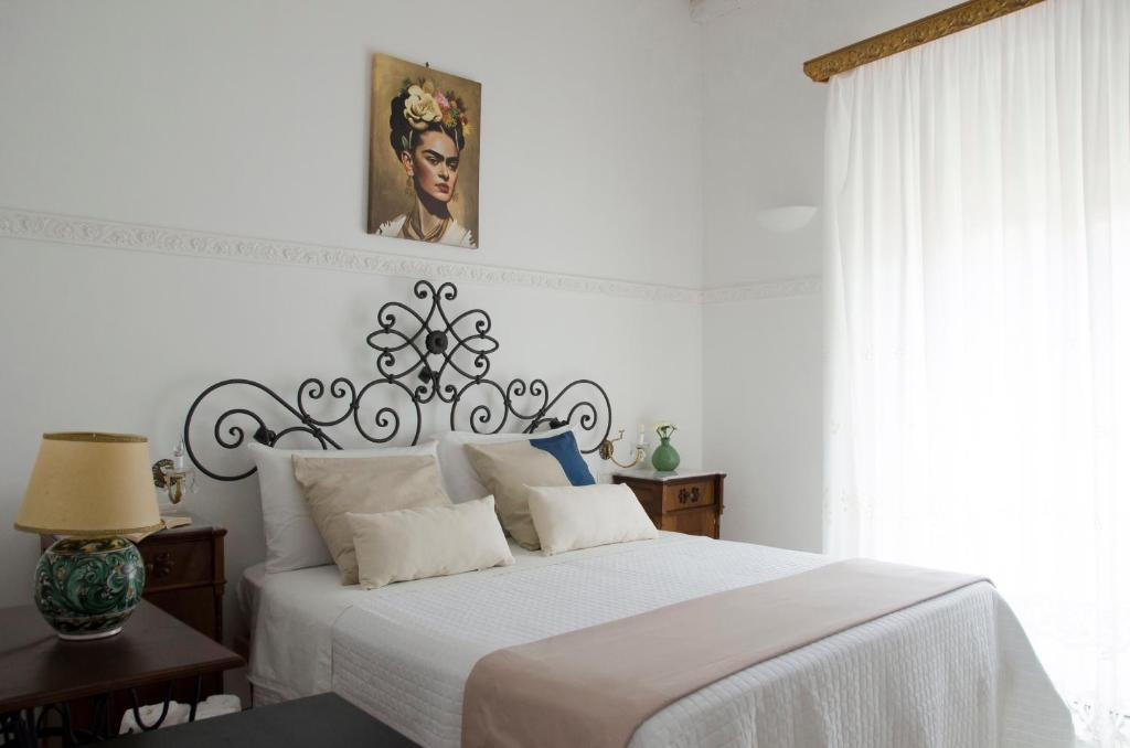 a white bedroom with a bed with a white bedspread at Casa Camelia - Cathedral View Apartment, 90m from Duomo in Noto