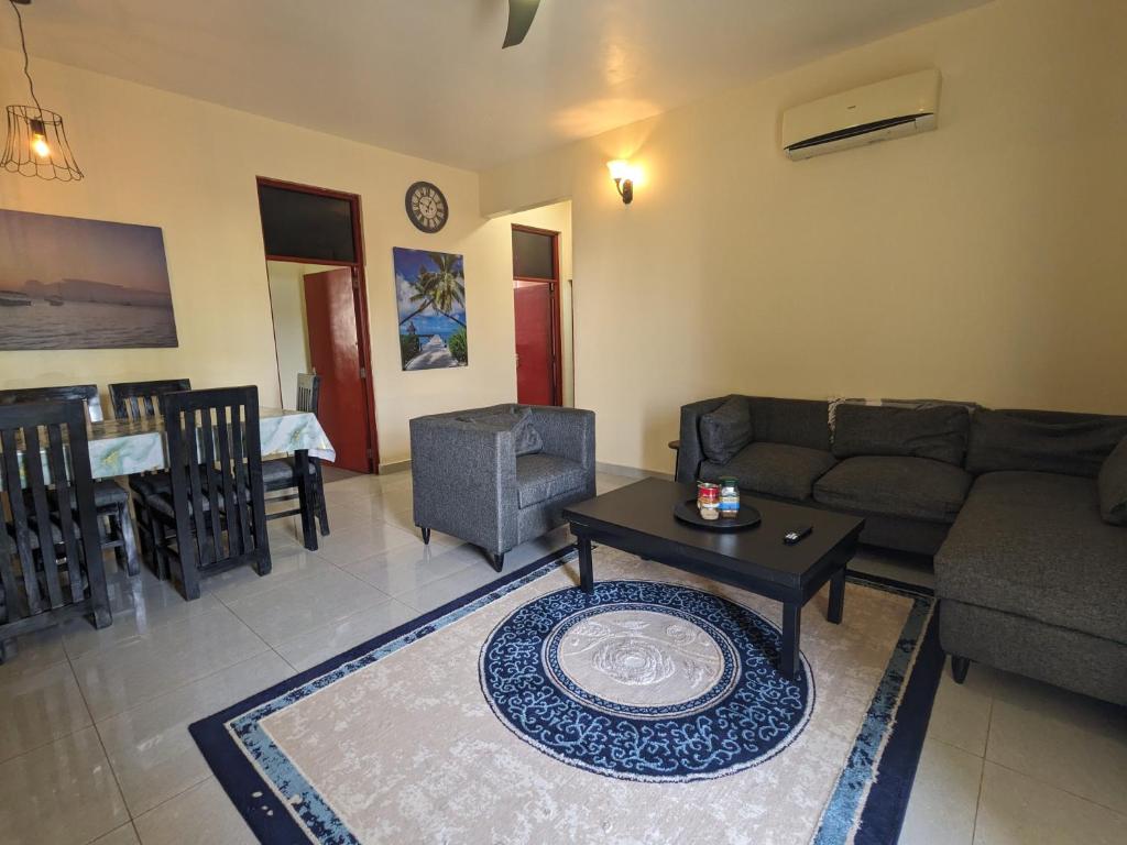 a living room with a couch and a table at Zanzi modern 2 bed apartment GF in Zanzibar City