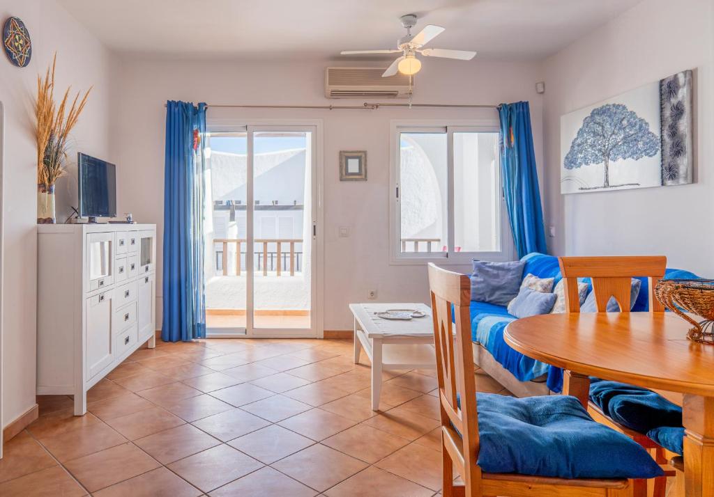 a living room with a table and a couch at Sirius in La Isleta del Moro