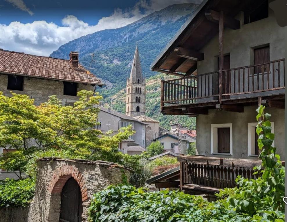a view of a town with a church in the background at Casa Pioda in Chiomonte