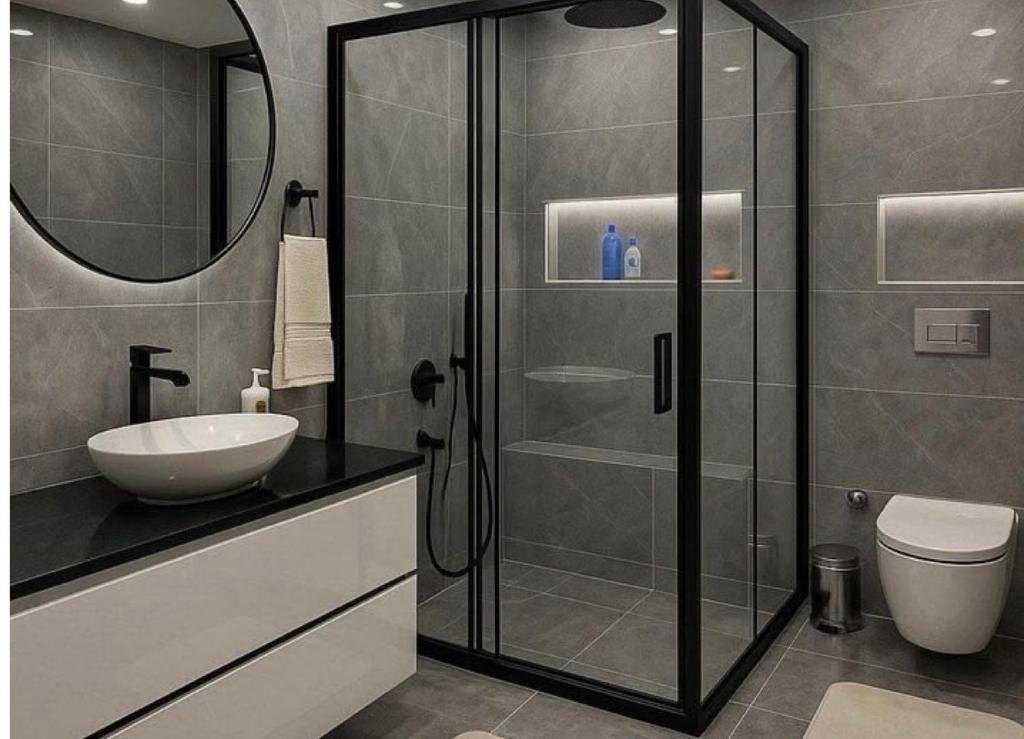 a bathroom with a glass shower and a sink at Dash-8 in Kigali