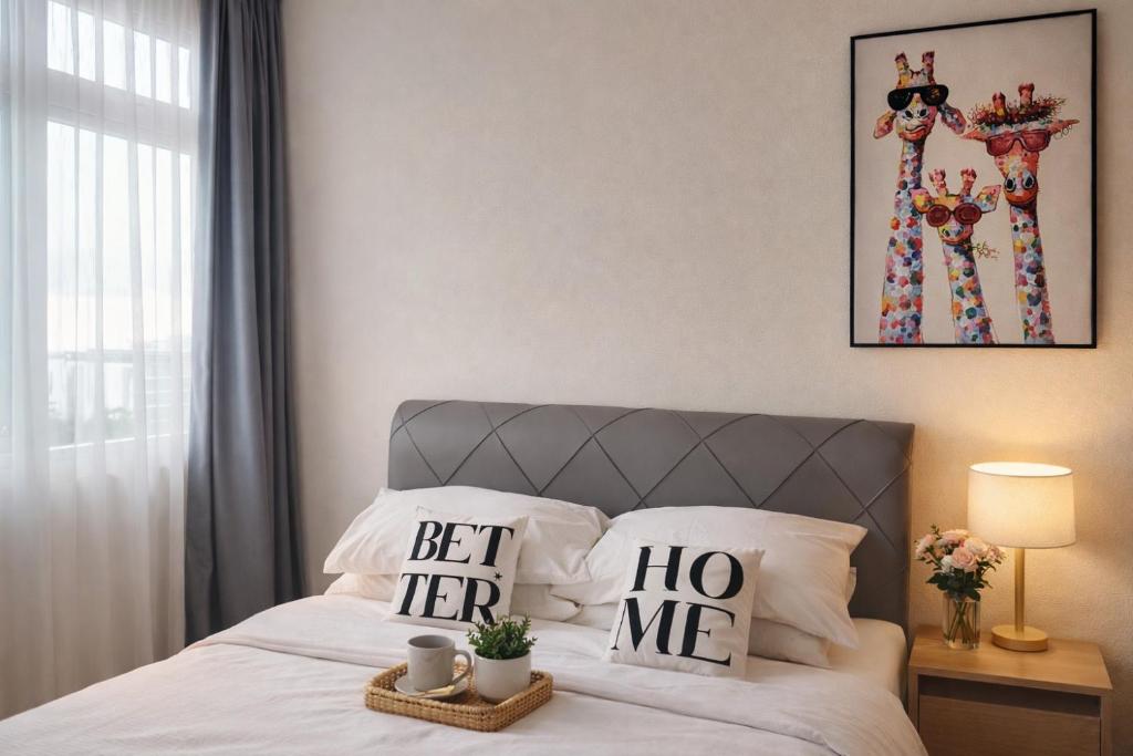 a bedroom with a bed with two pillows on it at The Foreigner Staycation at Riverine Diamond Kuching in Kuching
