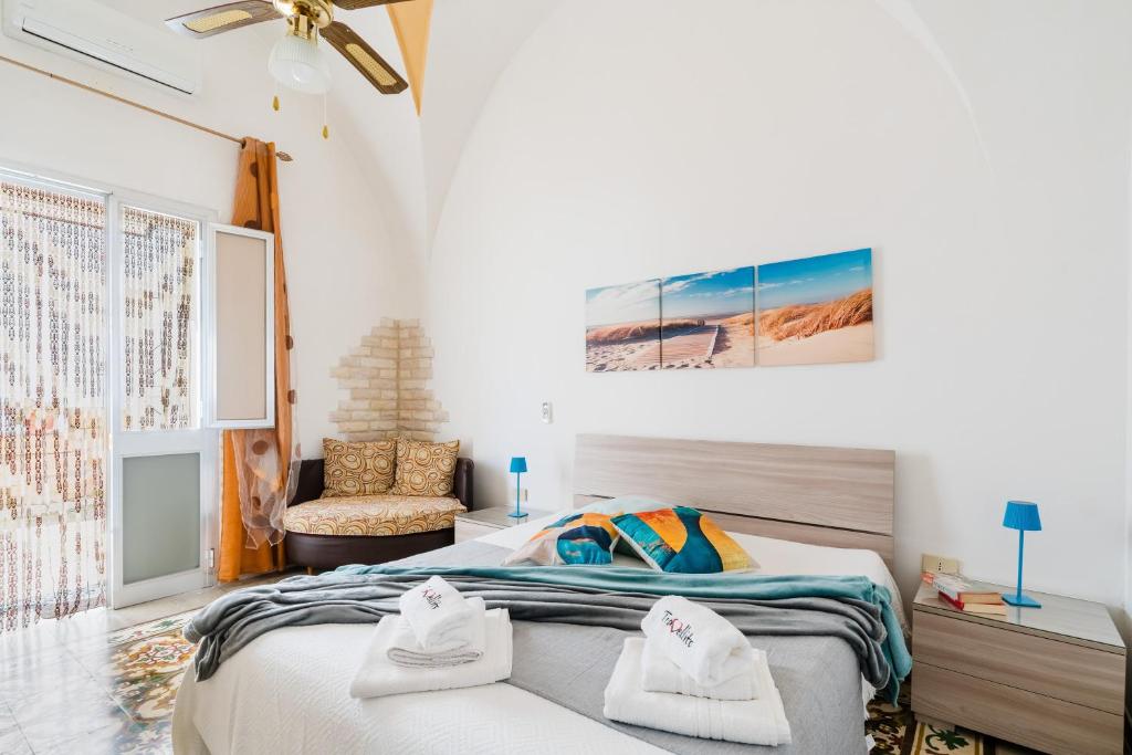 a bedroom with a bed with towels on it at Kyma monolocale ad Otranto in Otranto