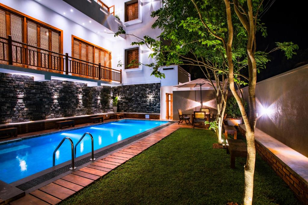 a swimming pool in the middle of a house at night at Meys Hiriketiya in Dickwella