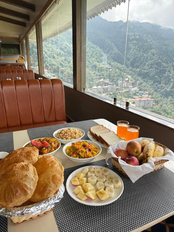 a table with different types of food on it at Avira Hotel in Gangtok